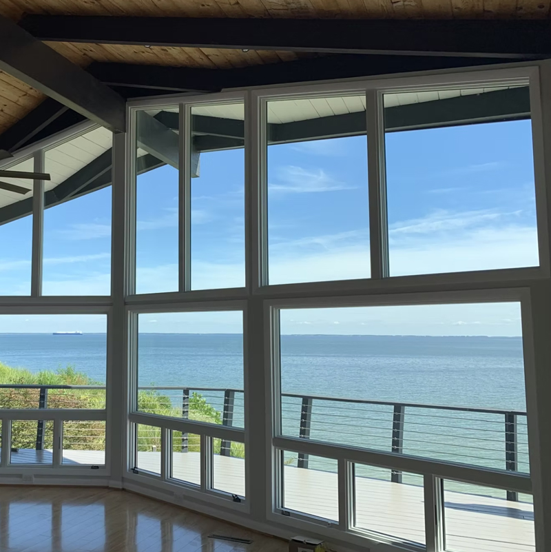 a screened porch with a waterfront view